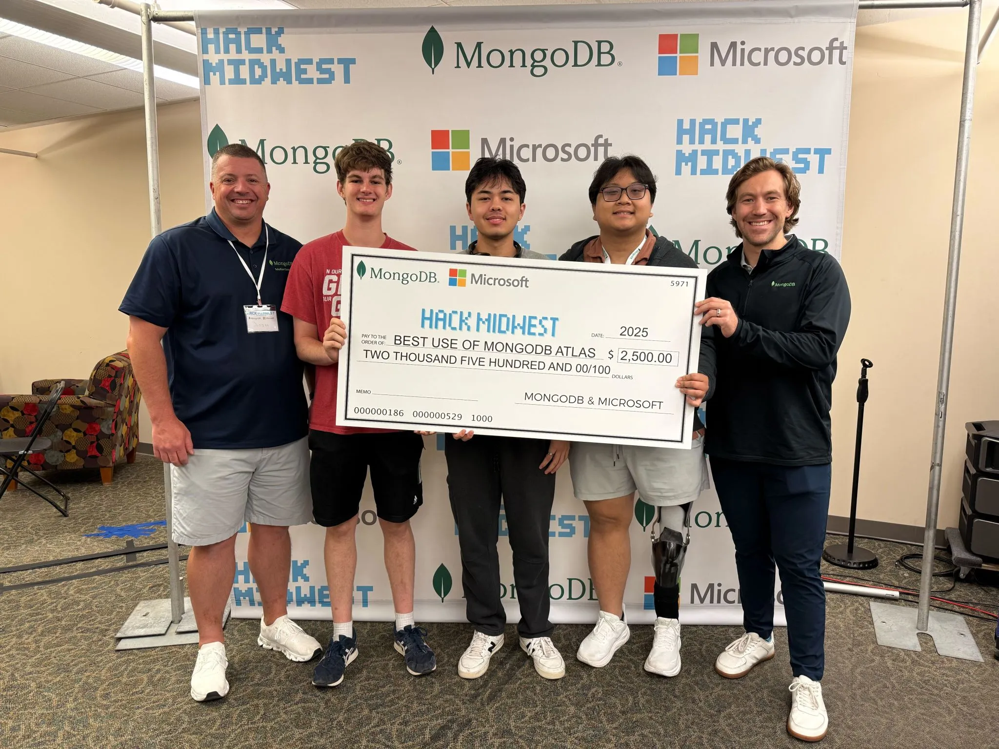 Picture of my hackathon team holding a prize check for $2,500