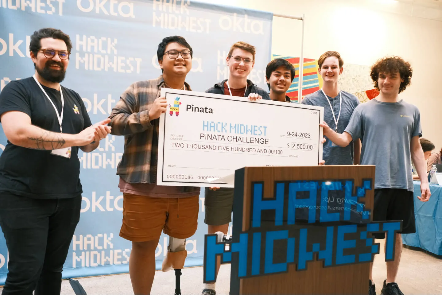 Picture of my hackathon team holding a prize check for $2,500
